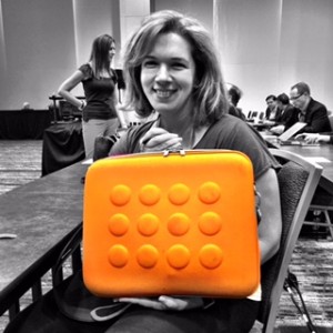 Tricia McKnight totes a geo-circle brief case in "It" color orange.
